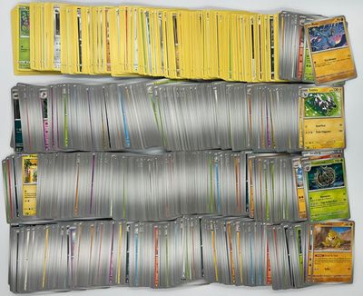 a lot of pokemon cards on the table