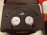 two gauges that are sitting in a case