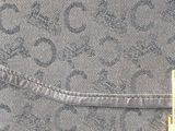 the back of a gray purse with a gold clasp
