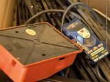 an orange box that is sitting on a pile of wires