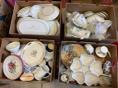boxes filled with assorted dishes and plates sitting on a floor