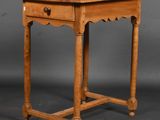 an old wooden table with a drawer on top of it