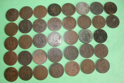 a close up of a pile of coins on a green surface