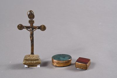 a cross, a box, and a ring on a table