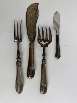 five forks, a knife, and a spoon on a table