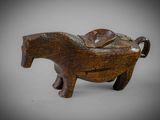 an image of a small wooden elephant with a saddle on it ' s back