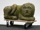 a stone sculpture sitting on top of a skateboard