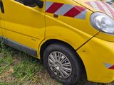 a small yellow van parked on the side of the road