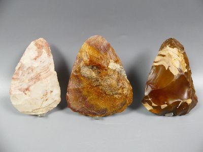 three different types of rocks on a gray surface