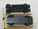 two toy trains sitting on top of a box
