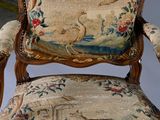 a chair that has been upholstered with a tapestry on it