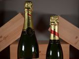 two bottles of champagne sitting next to each other on a table