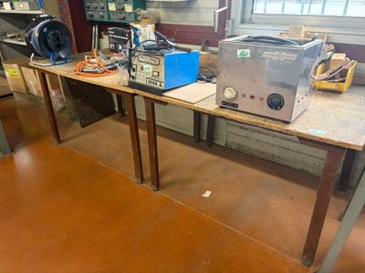 a table with a bunch of electronics on it in a room