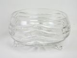 clear glass bowl with a wavy design on the bottom