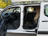 a white van with the door open and the driver ' s seat down