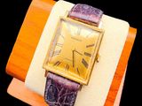 a watch that is sitting on top of a wooden stand