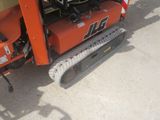 an image of a tractor with a small excavator attached to it