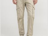 the man is wearing a brown t - shirt and khaki pants