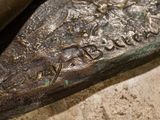 a bronze statue of a man holding a baseball bat