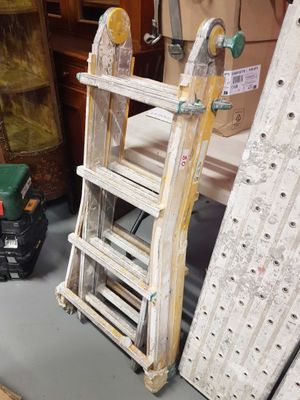a ladder that is sitting on the floor next to other items