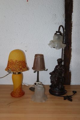 a table with a lamp, a lamp shade, and other items on it