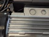 a close up of an electric motor on the ground