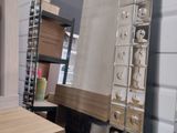 a large stack of boxes in a store with a mirror on the wall