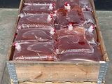 de nombreux sacs de viande dans une caisse en bois posée sur une palette