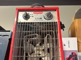 a red heater sitting on top of a shelf in a store