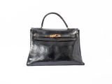 a black leather handbag on a white background