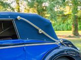a close up of a blue car parked in the grass