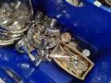 a blue tray with silverware and spoons in it