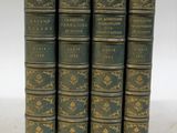 a set of five books with gold and green covers