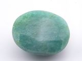 a close up of a green stone on a white surface