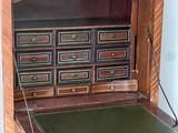 a wooden desk with drawers and drawers on it
