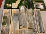many silverware items in a box on a table