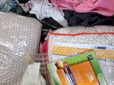 a suitcase full of items sitting on a bed