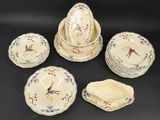 a group of porcelain plates and bowls with birds on them
