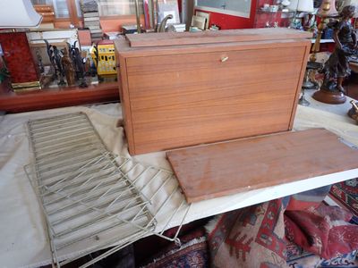 a wooden box sitting on top of a table next to a pile of other items