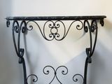 wrought iron console table with marble top and scroll design