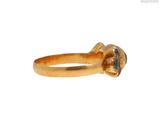 an image of a gold ring with a black diamond