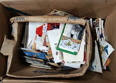 a cardboard box filled with many different types of papers