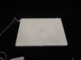 an apple laptop computer sitting on top of a table next to a charger