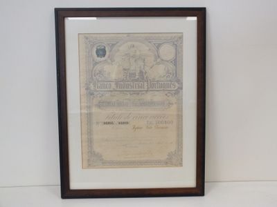 un vieux certificat est accroché au mur, devant un mur blanc