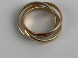 three gold rings on a white surface with a white background
