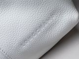 the white leather wallet is open and ready to be used
