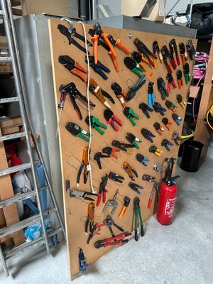 many tools hanging on the wall in the garage