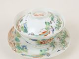 a bowl and saucer on a saucer on a white table