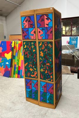 a wooden cabinet with a colorful design painted on it