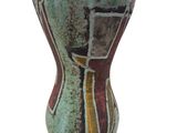 a close up of a vase on a white surface